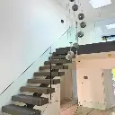 Central spine staircase design with glass balustrade 7.webp